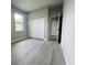 Bedroom features a closet, light gray walls, and light gray wood-look flooring at 3045 Montgomery Dr, Port Charlotte, FL 33981