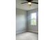Bedroom with a ceiling fan, gray walls, and light gray wood-look flooring at 3045 Montgomery Dr, Port Charlotte, FL 33981