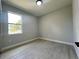 Bright bedroom with light gray walls and light gray wood-look flooring and a bright window at 3045 Montgomery Dr, Port Charlotte, FL 33981