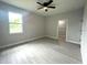 Bedroom with ceiling fan, light gray walls and light gray wood-look flooring and a closet at 3045 Montgomery Dr, Port Charlotte, FL 33981