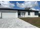 Charming single-story home boasting a two-car garage and a patterned brick driveway at 3045 Montgomery Dr, Port Charlotte, FL 33981