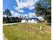 Charming single-Gathering home featuring a freshly painted exterior, attached garage, and well-maintained lawn at 3045 Montgomery Dr, Port Charlotte, FL 33981