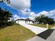 Inviting home with a long driveway and a well-kept lawn, perfect for curb appeal at 3045 Montgomery Dr, Port Charlotte, FL 33981
