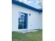The exterior of the home features a sliding glass door and a small patio area at 3045 Montgomery Dr, Port Charlotte, FL 33981