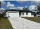 Charming single-story home features a spacious two-car garage and beautifully patterned brick driveway at 3045 Montgomery Dr, Port Charlotte, FL 33981