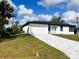 Well-maintained single-story home features a two-car garage and a lovely patterned brick driveway at 3045 Montgomery Dr, Port Charlotte, FL 33981