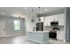 Modern, open-concept kitchen with stainless steel appliances, a kitchen island, and pendant lighting at 3045 Montgomery Dr, Port Charlotte, FL 33981