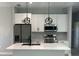 Modern kitchen with white cabinets, stainless steel appliances, and a stylish island with a double sink at 3045 Montgomery Dr, Port Charlotte, FL 33981