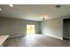 Living room featuring backyard access and sleek light gray wood-look floors at 3045 Montgomery Dr, Port Charlotte, FL 33981