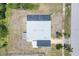 Overhead shot of home with dark and light roofing, surrounded by greenery and neighborhood streets at 330 Lasayette Ne Dr, Port Charlotte, FL 33952