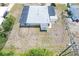 Birds-eye view of home surrounded by a large yard and neighboring properties under clear skies at 330 Lasayette Ne Dr, Port Charlotte, FL 33952