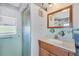 Bathroom featuring a vanity with a stylish mirror and a convenient shower with glass door at 330 Lasayette Ne Dr, Port Charlotte, FL 33952