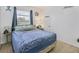 Cozy bedroom features nautical decor, comfortable queen bed, and natural light from window at 330 Lasayette Ne Dr, Port Charlotte, FL 33952