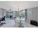 Bright dining room featuring a glass table and sliding door to a screened porch at 330 Lasayette Ne Dr, Port Charlotte, FL 33952