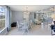 Inviting dining area with tile floors, a table with white chairs, and nearby living space at 330 Lasayette Ne Dr, Port Charlotte, FL 33952