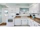 Cozy kitchen featuring white cabinetry, modern appliances, and beach-themed decor at 330 Lasayette Ne Dr, Port Charlotte, FL 33952