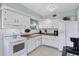 Bright kitchen with white cabinets and stainless steel appliances for easy modern living at 330 Lasayette Ne Dr, Port Charlotte, FL 33952