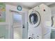 Convenient laundry area features stacked washer/dryer units and an exterior door at 330 Lasayette Ne Dr, Port Charlotte, FL 33952