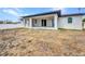 Exterior of the home showcasing a large backyard and covered patio area at 3380 Elkcam Blvd, Port Charlotte, FL 33952