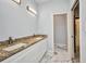 Bathroom with double granite vanity and large tile floors at 3380 Elkcam Blvd, Port Charlotte, FL 33952