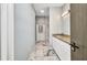 Bathroom with granite vanity, large tile floors, and access to the shower and tub at 3380 Elkcam Blvd, Port Charlotte, FL 33952