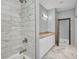 Tastefully remodeled bathroom with tub and shower, granite countertop and marble flooring at 3380 Elkcam Blvd, Port Charlotte, FL 33952