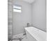 Freestanding tub with modern faucet and marble floor and walls at 3380 Elkcam Blvd, Port Charlotte, FL 33952