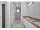 Long bathroom with granite vanity, marble floors, and a freestanding tub at 3380 Elkcam Blvd, Port Charlotte, FL 33952