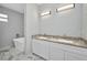 Bathroom with double granite vanity, marble floors, and a freestanding tub at 3380 Elkcam Blvd, Port Charlotte, FL 33952