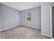 Empty bedroom with luxury vinyl plank flooring and a bright window at 3380 Elkcam Blvd, Port Charlotte, FL 33952