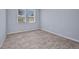 Light-filled room features luxury vinyl plank flooring and dual windows at 3380 Elkcam Blvd, Port Charlotte, FL 33952