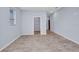Empty bedroom showing wood-look floors, a walk-in closet, and freshly painted walls at 3380 Elkcam Blvd, Port Charlotte, FL 33952