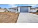 Charming single-story home featuring a new driveway and attached one car garage at 3380 Elkcam Blvd, Port Charlotte, FL 33952