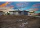 Charming single-story home featuring a new driveway and attached one car garage at sunset at 3380 Elkcam Blvd, Port Charlotte, FL 33952