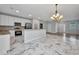 A modern kitchen features stainless steel appliances, granite countertops, and sleek marble flooring at 3380 Elkcam Blvd, Port Charlotte, FL 33952