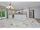 Modern kitchen features stainless steel appliances, granite countertops, and sleek marble flooring at 3380 Elkcam Blvd, Port Charlotte, FL 33952