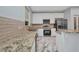 Bright kitchen featuring granite countertops, modern appliances, subway tile backsplash, and stylish marble floors at 3380 Elkcam Blvd, Port Charlotte, FL 33952