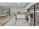 Well-equipped kitchen with granite counters, stainless appliances, and a view to the outdoor space at 3380 Elkcam Blvd, Port Charlotte, FL 33952