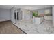 Bright open floor plan showcasing a modern kitchen with marble floors and stainless steel appliances at 3380 Elkcam Blvd, Port Charlotte, FL 33952