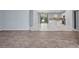 Open-concept living room flows into the kitchen with white cabinets and modern appliances at 3380 Elkcam Blvd, Port Charlotte, FL 33952