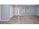 Inviting living room with wood laminate flooring, a closet, and a bright front door at 3380 Elkcam Blvd, Port Charlotte, FL 33952