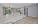 Open-concept living room flows into the kitchen with white cabinets and modern appliances at 3380 Elkcam Blvd, Port Charlotte, FL 33952