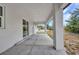 Covered patio offers expansive outdoor living space with mature landscaping at 3380 Elkcam Blvd, Port Charlotte, FL 33952