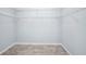 A walk-in closet with a white wire shelving system and wood-look floors at 3380 Elkcam Blvd, Port Charlotte, FL 33952