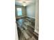 Bedroom featuring wood-look tile floors, a ceiling fan, and a window letting in natural light at 340 Sweetwater Dr, Rotonda West, FL 33947
