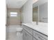 The bathroom showcases a modern vanity, sleek fixtures, and a tiled shower over tub, perfect for relaxation at 3560 Elias Cir, North Port, FL 34288