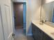 Bathroom with ceramic tiled shower, tile flooring, and vanity at 3560 Elias Cir, North Port, FL 34288