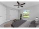 Bright bedroom with ceiling fan, double door closet and large window with outdoor view at 3560 Elias Cir, North Port, FL 34288