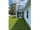 Back exterior view of the home, featuring a screened-in patio and well-maintained lawn at 3560 Elias Cir, North Port, FL 34288
