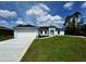 Charming single-story home with a well-manicured lawn, bright facade, and a two-car garage at 3560 Elias Cir, North Port, FL 34288